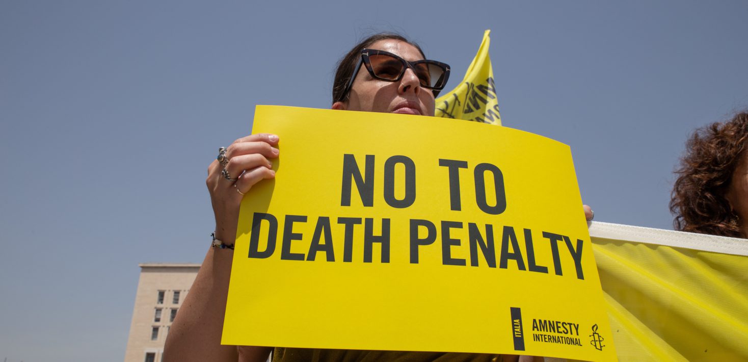 Activist holding placard No to Death Penalty. Amnesty